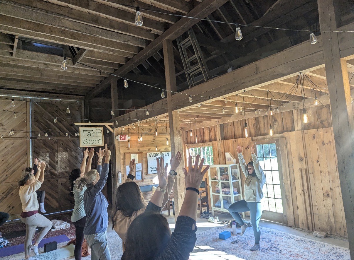 Retreat participants practicing yoga together in the Evergreen Farm barn